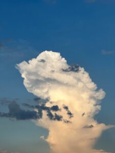 towering cumulonimbus cloud over blue sky