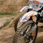 dirt bikes parked on dirt road