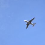 airplane flying in clear blue sky