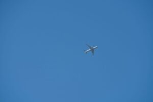 commercial airplane flying in blue sky