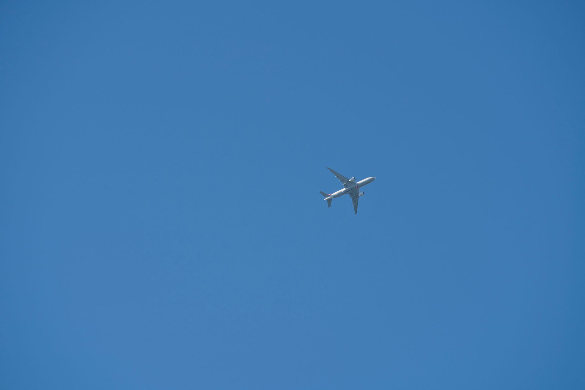 commercial airplane flying in blue sky