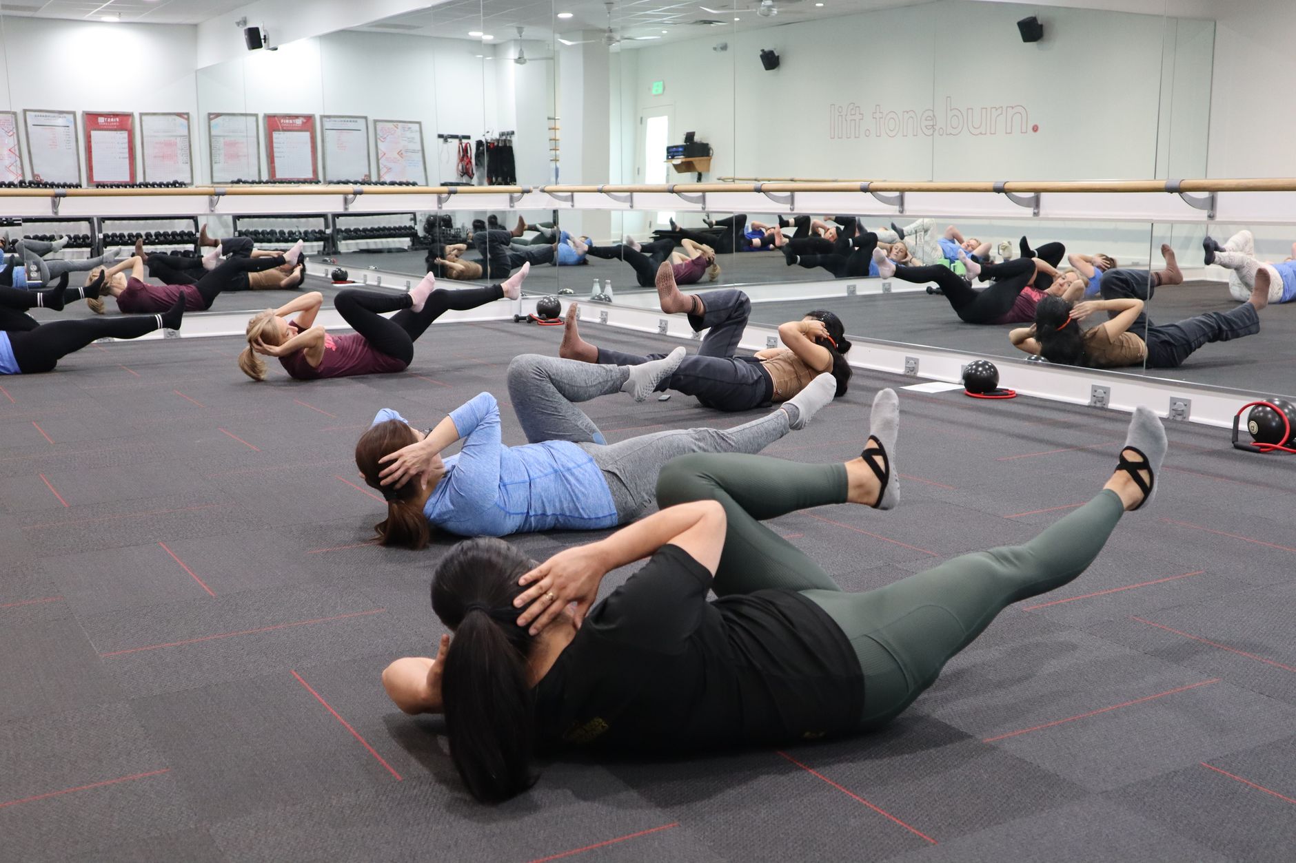 group fitness class engaged in intense core workout