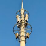 close up of cellular tower against blue sky
