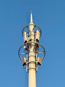 close up of cellular tower against blue sky