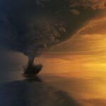 tornado on body of water during golden hour